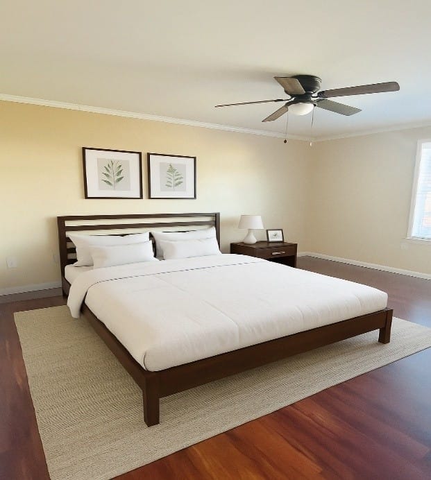 A Pineview bedroom with a king bed, a ceiling fan, framed art, hardwood-look flooring, and an area rug