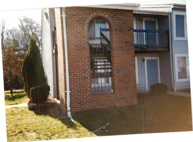 A brick breezeway with an arched opening and a staircase between two Pineview buildings